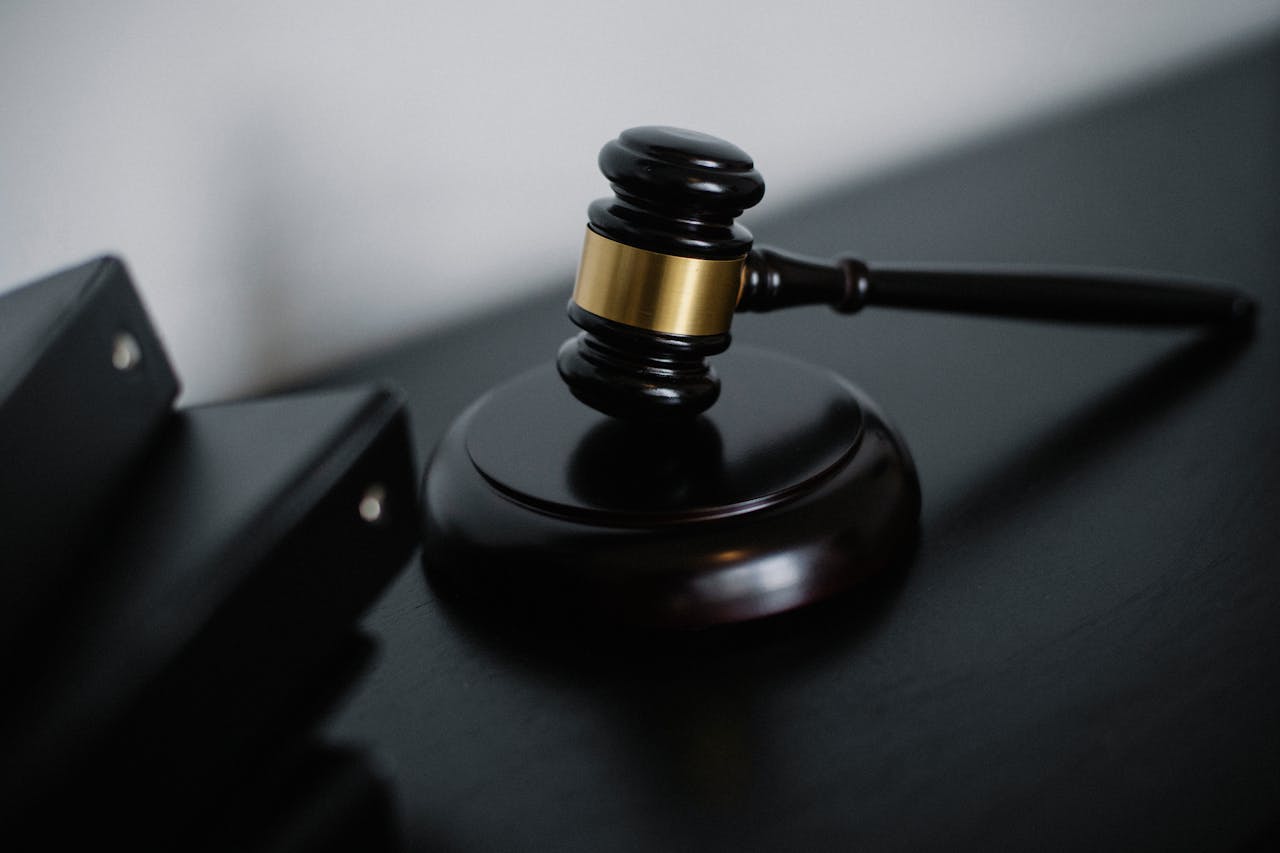 why-choose-me Close-up of a wooden gavel on a desk, symbolizing justice and legal authority.